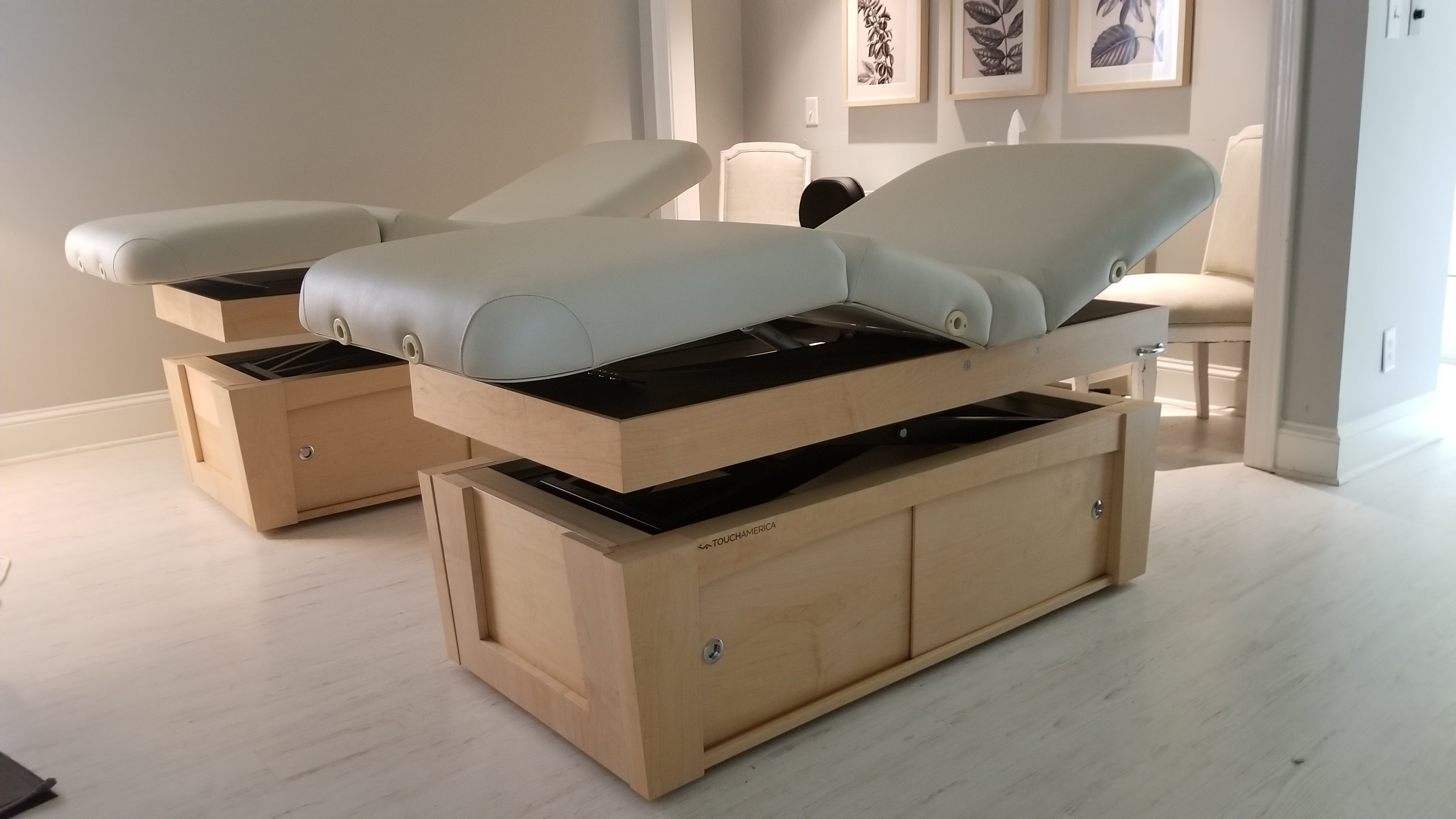 Custom maple cabinetry and treatment table millwork in a bright treatment room